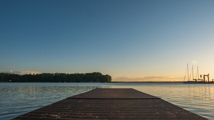 Fototapeta na wymiar Wooden pier On Masurian lake.