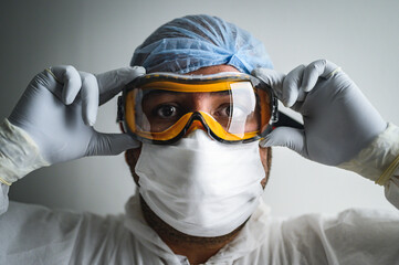 doctor and his protective equipment to fight covid19  - 368535559