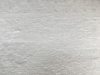 White natural woven linen fabric texture. Solid light background for design. A close up of a rug. High quality photo