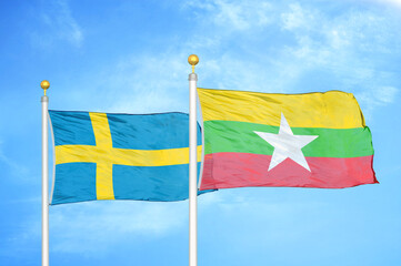Sweden and Myanmar two flags on flagpoles and blue sky