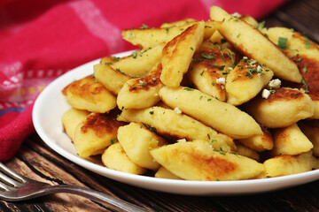 Polish dish kopytka served at the table	