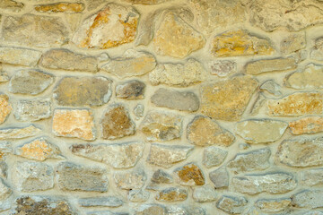 Different size stone blocks wall close up as background