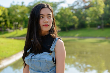 Fototapeta premium Young beautiful Asian woman at the park outdoors