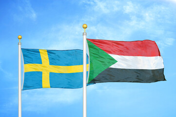 Sweden and Sudan two flags on flagpoles and blue sky