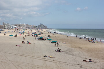 People sunbathe on the beach in Ocean City MD