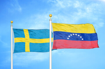 Sweden and Venezuela two flags on flagpoles and blue sky