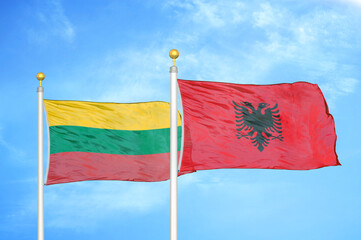 Lithuania and Albania two flags on flagpoles and blue sky