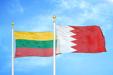Lithuania and Bahrain two flags on flagpoles and blue sky