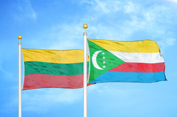 Lithuania and Comoros two flags on flagpoles and blue sky