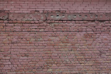 red stone texture from old brick wall of building on the street