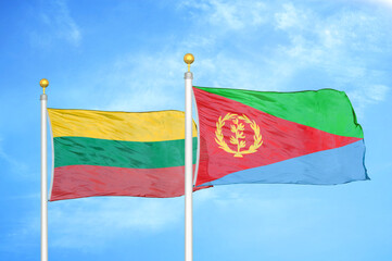 Lithuania and Eritrea two flags on flagpoles and blue sky