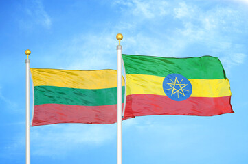 Lithuania and Ethiopia two flags on flagpoles and blue sky