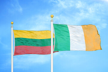 Lithuania and Ireland two flags on flagpoles and blue sky