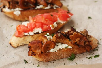 Bruschetta with red tomatoes and chanterelles macro