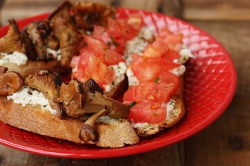 Bruschetta with red tomatoes and chanterelles macro