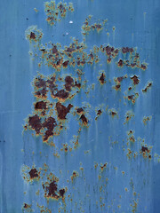 Rusty metal panel with cracked blue paint, corroded grunge metal background