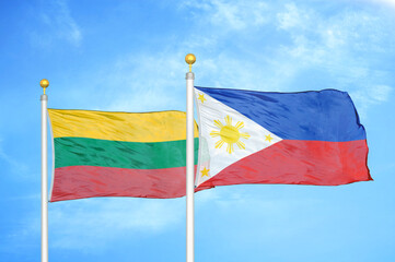 Lithuania and Philippines two flags on flagpoles and blue sky