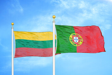 Lithuania and Portugal two flags on flagpoles and blue sky