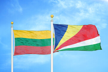 Lithuania and Seychelles two flags on flagpoles and blue sky