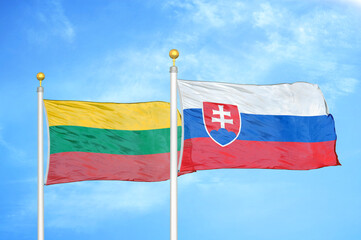 Lithuania and Slovakia two flags on flagpoles and blue sky