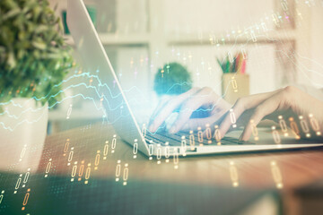 Double exposure of woman hands typing on computer and forex chart hologram drawing. Stock market invest concept.