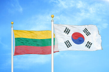 Lithuania and South Korea two flags on flagpoles and blue sky