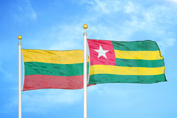 Lithuania and Togo two flags on flagpoles and blue sky