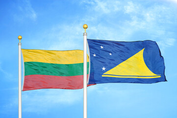 Lithuania and Tokelau two flags on flagpoles and blue sky