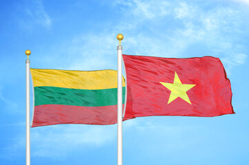 Lithuania and Vietnam two flags on flagpoles and blue sky