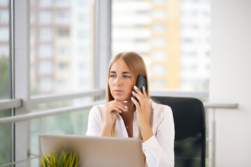 Focused woman working at her computer. Background for office startup