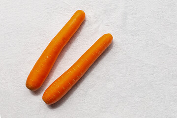 pair of fresh orange carrots on a white background. Delicious healthy root for snack