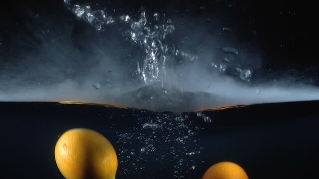 Shooting of falling granadilla in the water with smoke