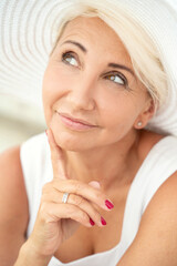 Portrait of middle age beautiful woman in hat.