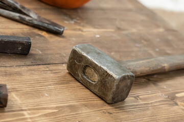 old hammer sledge hammer tool for building rests on wooden planks