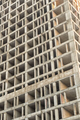 gray cement building construction of an apartment building close-up vertical photo