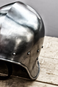 round iron helmet protection of the medieval warrior close-up stands on the table