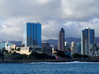 Wave crashes against rock seawall at Kaka`ako Waterfront Park