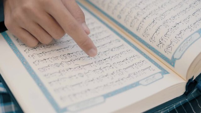 Asian muslim young man sitting reads a koran book, Study education of religious teachings