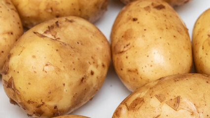 A slide of fresh young potatoes on the white background. The new harvest. Raw potatoes. Agriculture concept.