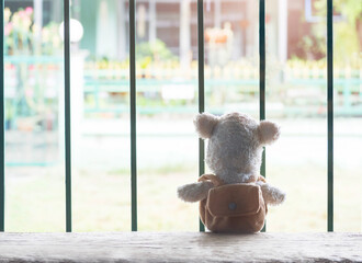 Alone teddy bear sitting with 
Steel cage. broken heart concept.