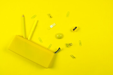 set of school stationery and pencil case in yellow monochrome concept