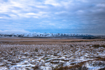 Mountains in the distance on  the Dempster Highway  in the Yukon on Road trip after first snow 