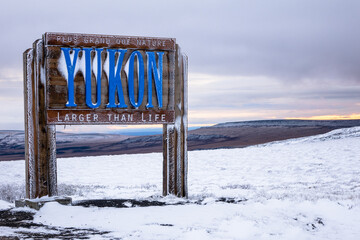 Welcome to the Yukon sign on the Dempster Highway after first snow 