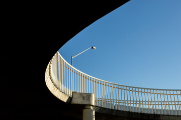 looking up at the curve of a bridge