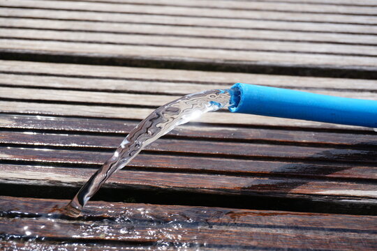 Close up of water hose where water comes out. Water wastage.