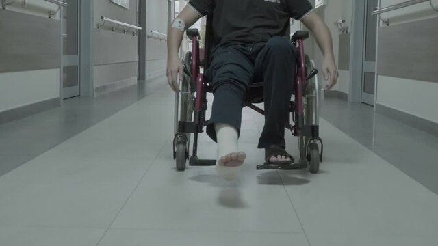 Patient in Wheelchair In The Hospital Hall