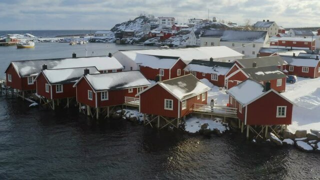 famous multicolored wooden fishing houses rorbu on a sea shore