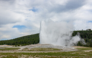Amazing view of the Old Faithful Geyser at Yellowstone, Wyoming, USA
