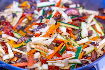 Food photograph of vegetables cooked in a pan - delicious zucchini, peppers, mushrooms, onions, healthy dinner