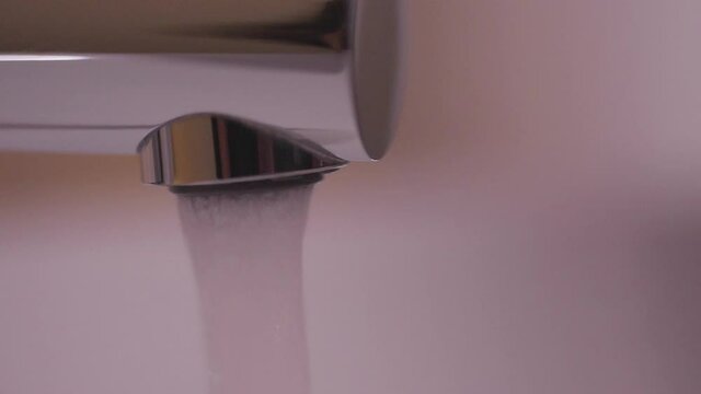 turning off faucet droping water in lavatory on bathroom slow motion	
